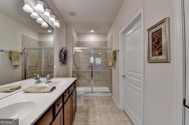 bathroom featuring vanity, tile patterned floors, a shower with shower door, and toilet