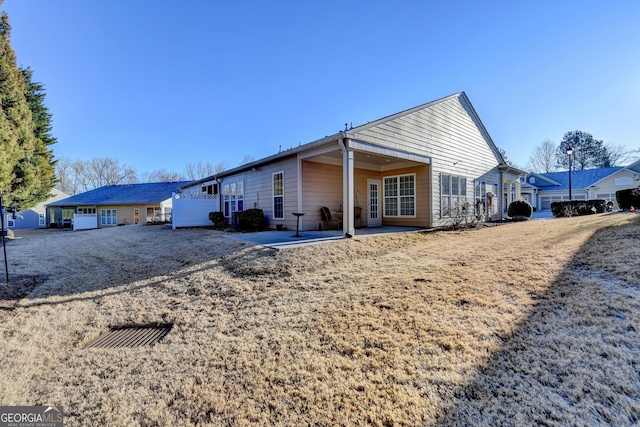 back of property with a patio