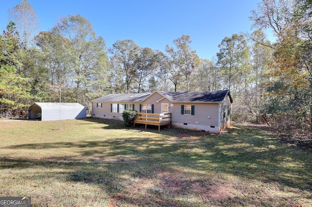 rear view of house with a yard, a deck, and a carport