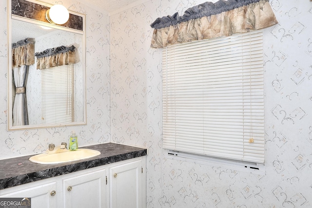 bathroom with a textured ceiling and vanity