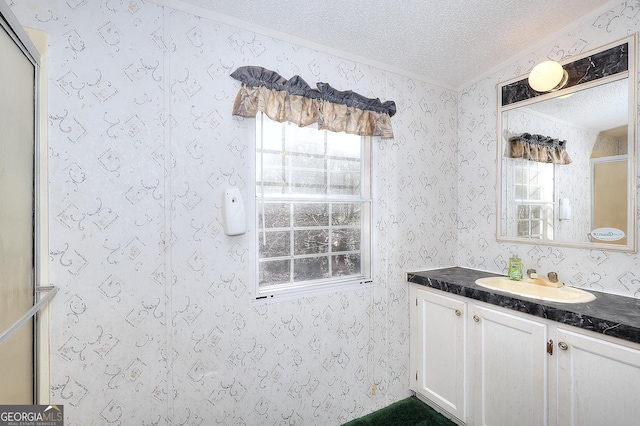 bathroom with vanity, walk in shower, and a textured ceiling