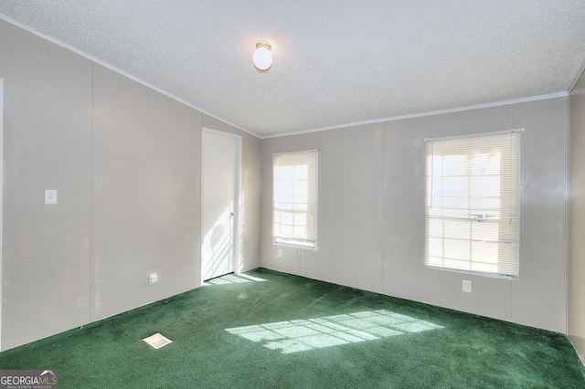 unfurnished room featuring a textured ceiling, crown molding, and dark colored carpet