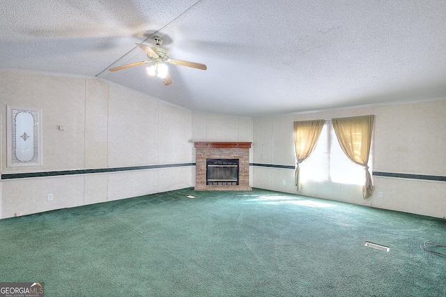 unfurnished living room featuring carpet flooring, a textured ceiling, a fireplace, vaulted ceiling, and ceiling fan