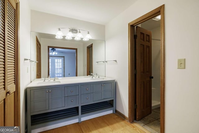 bathroom featuring ceiling fan, hardwood / wood-style floors, and vanity