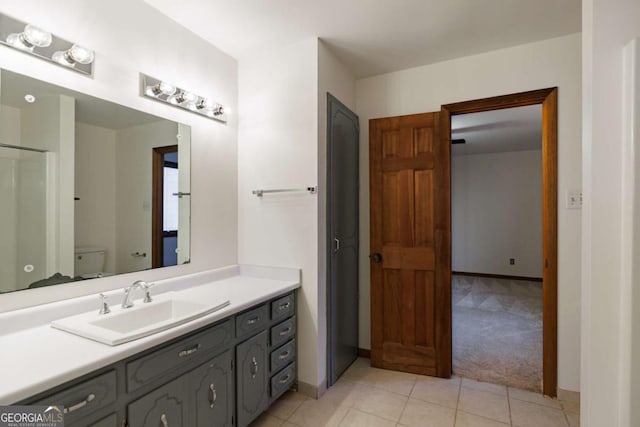 bathroom featuring toilet, vanity, and tile patterned floors