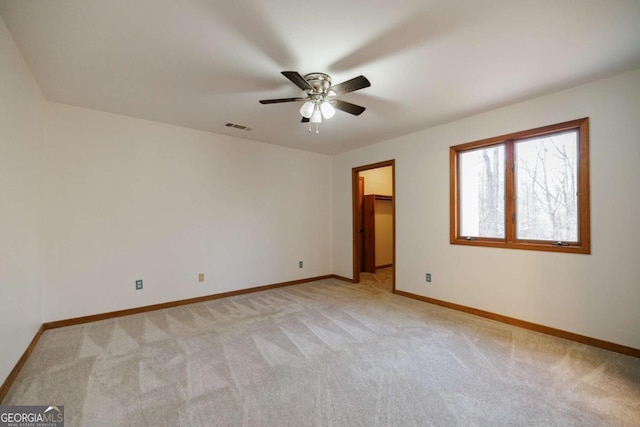 carpeted spare room with ceiling fan