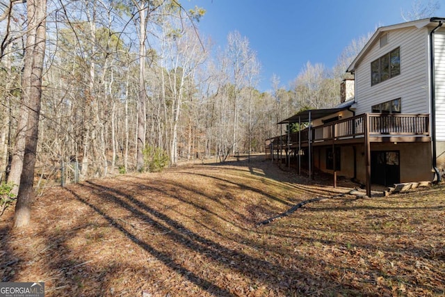 view of yard with a wooden deck