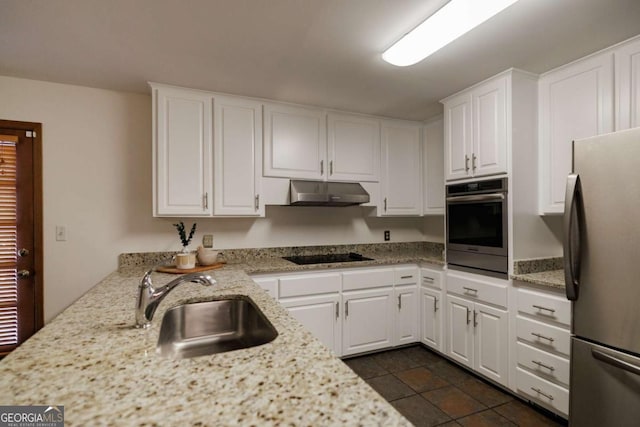 kitchen featuring stainless steel appliances, white cabinets, sink, and light stone countertops