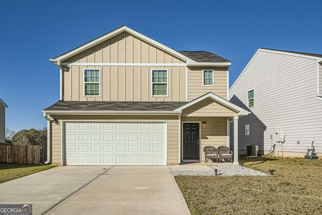 front facade with a front yard, a garage, and central AC