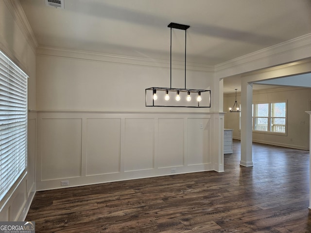 unfurnished dining area with a decorative wall, dark wood-style floors, visible vents, and ornamental molding