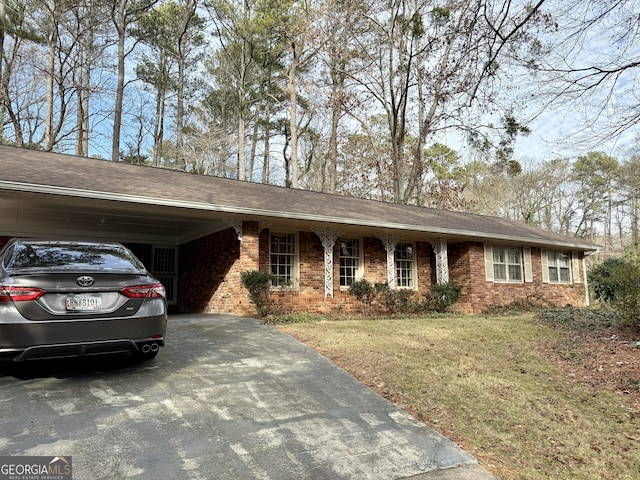 ranch-style house with a carport and a front lawn