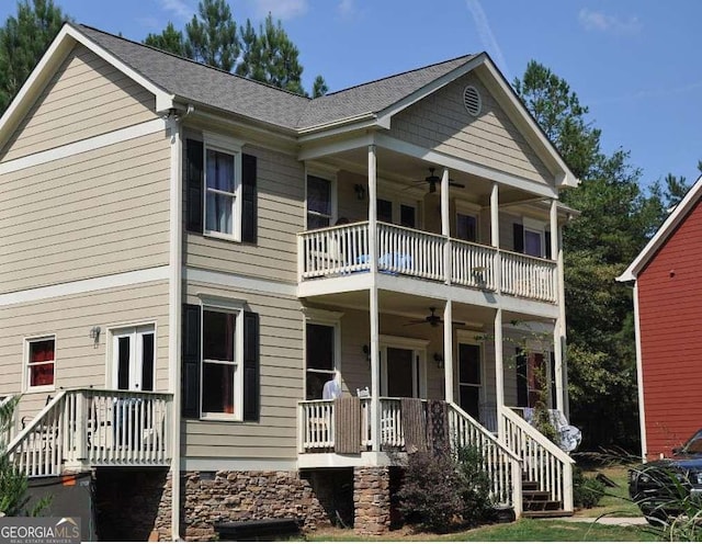 view of front of property with covered porch, ceiling fan, and a balcony