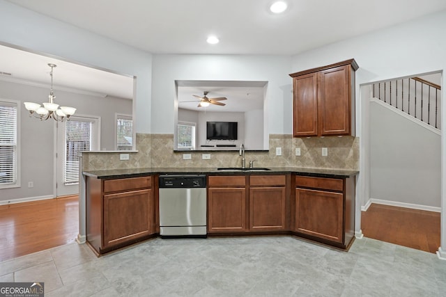 kitchen with dishwasher, sink, decorative backsplash, and dark stone counters