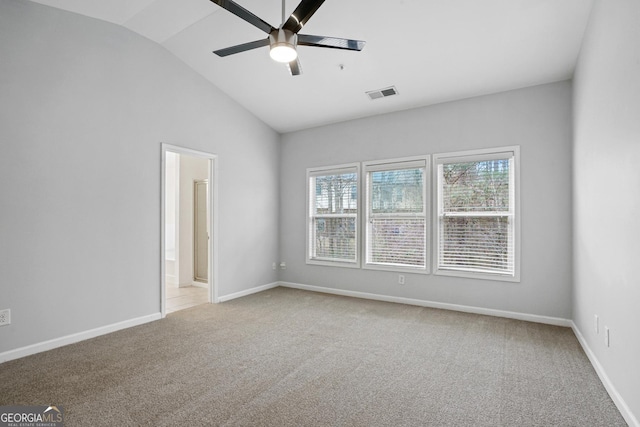 unfurnished room with lofted ceiling, light carpet, and ceiling fan