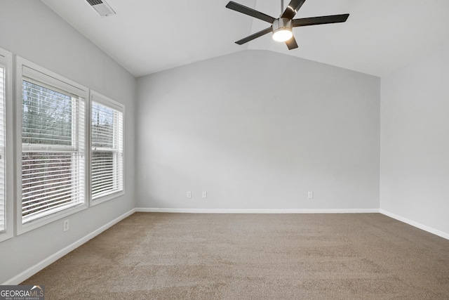 carpeted empty room with lofted ceiling and ceiling fan