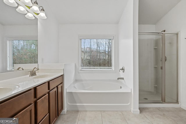 bathroom featuring tile patterned flooring, vanity, a healthy amount of sunlight, and a chandelier