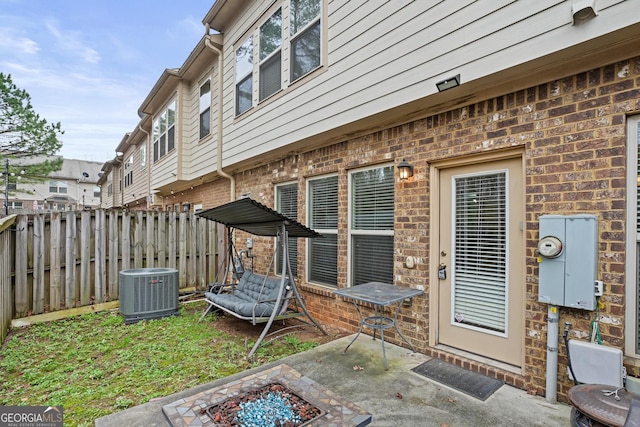 view of patio with cooling unit and a fire pit