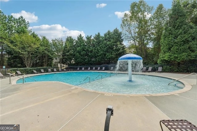 view of swimming pool with pool water feature