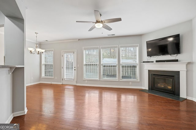 unfurnished living room with hardwood / wood-style floors and ceiling fan with notable chandelier