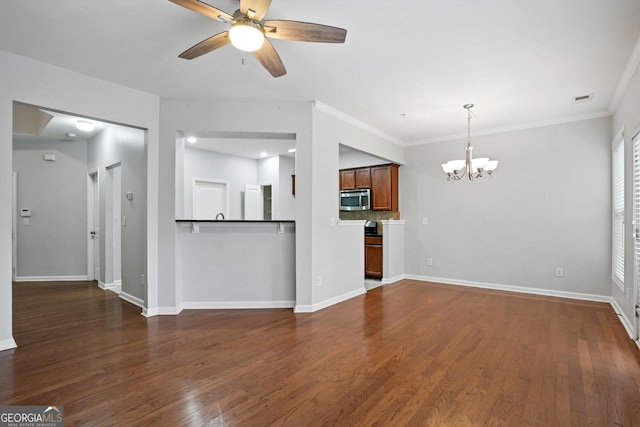 unfurnished living room with crown molding, ceiling fan with notable chandelier, and dark wood-type flooring