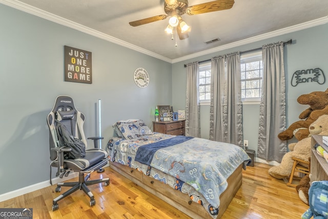 bedroom featuring wood-type flooring, ceiling fan, and crown molding