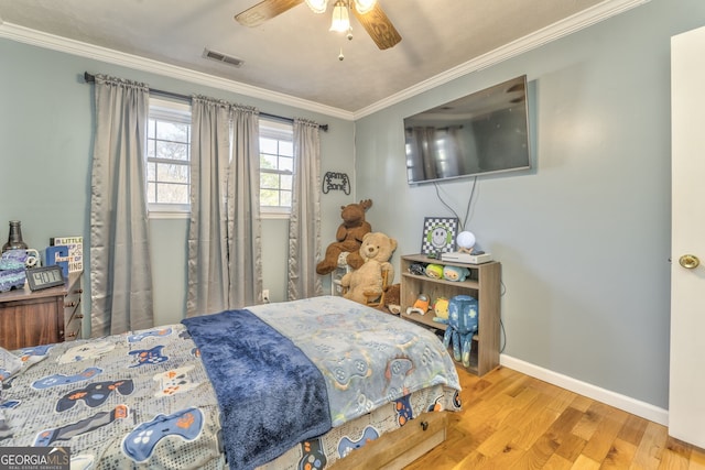 bedroom with wood-type flooring, ceiling fan, and crown molding