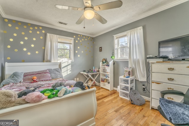 bedroom featuring multiple windows, a textured ceiling, ceiling fan, and light hardwood / wood-style flooring