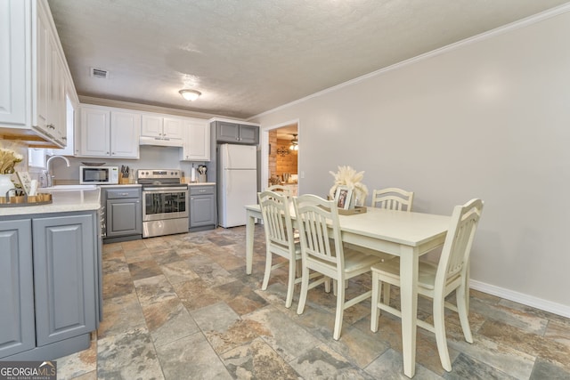 kitchen with gray cabinetry, white cabinetry, stainless steel electric range oven, white refrigerator, and sink