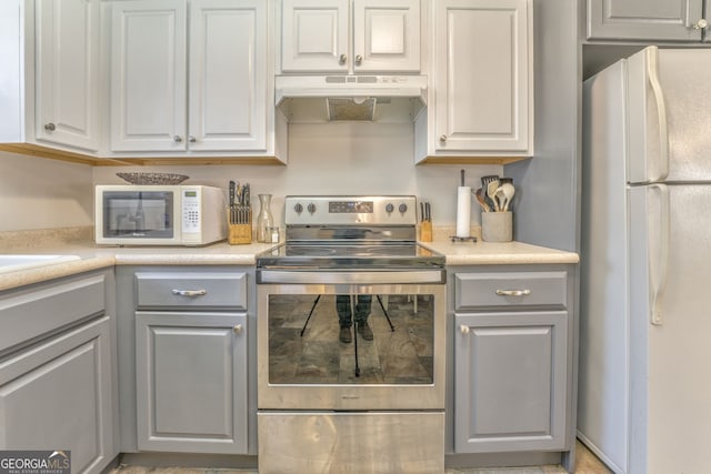 kitchen with white appliances and gray cabinetry