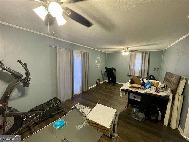 interior space featuring a textured ceiling, dark hardwood / wood-style flooring, crown molding, and ceiling fan