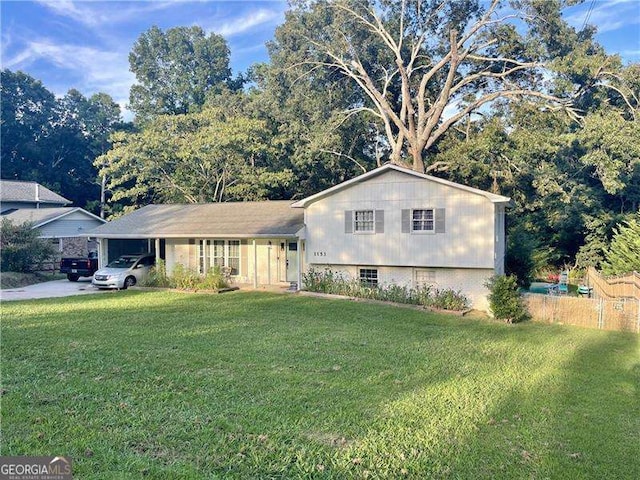 split level home with a front yard and a carport