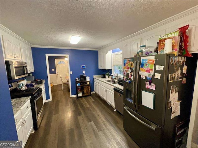 kitchen with stainless steel appliances, crown molding, a textured ceiling, dark hardwood / wood-style floors, and white cabinets