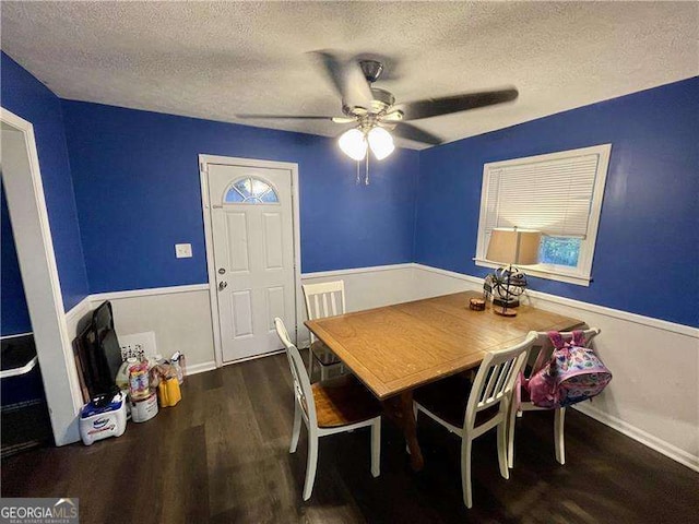 dining space with a textured ceiling, ceiling fan, and dark hardwood / wood-style floors