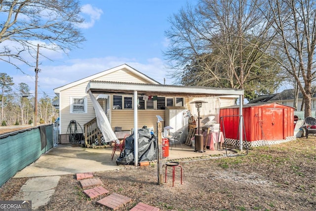 rear view of property with a shed