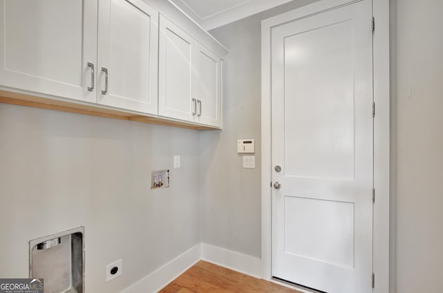 washroom with washer hookup, cabinets, light hardwood / wood-style floors, and hookup for an electric dryer