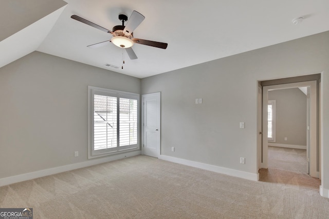 unfurnished room featuring ceiling fan, light carpet, and lofted ceiling