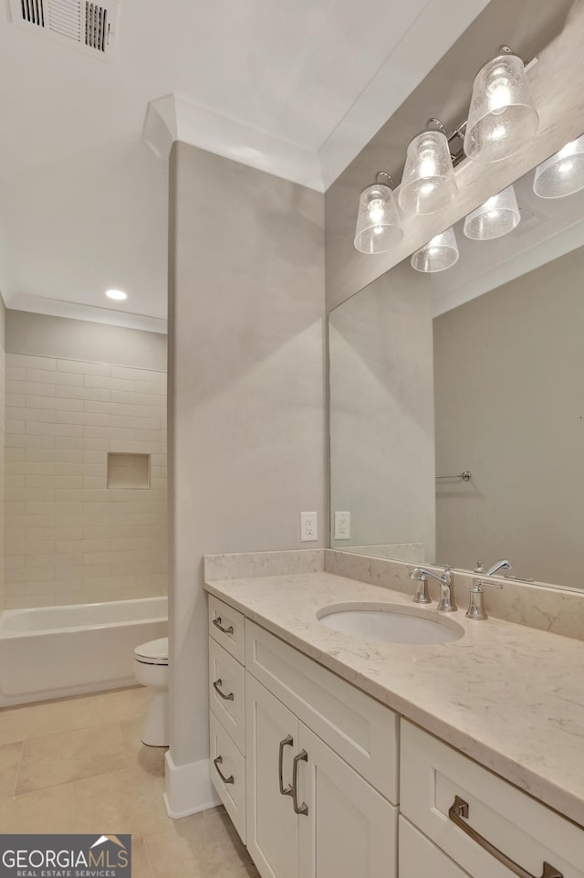 full bathroom with tile patterned flooring, tiled shower / bath combo, vanity, and toilet