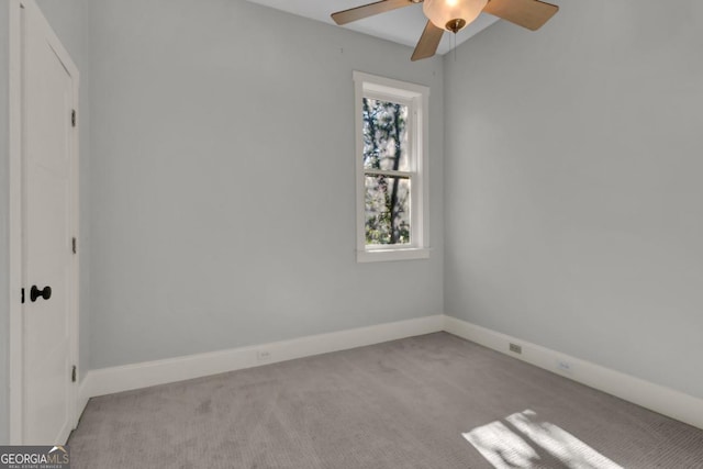 spare room with ceiling fan and light colored carpet