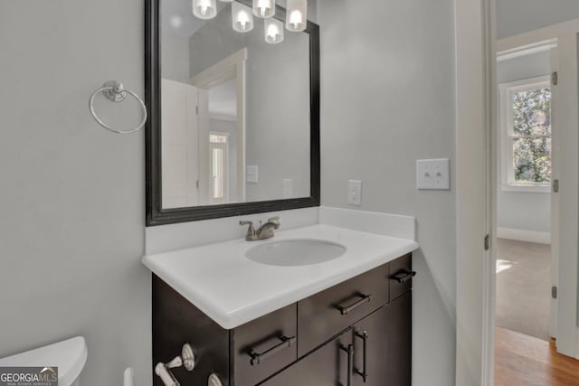 bathroom featuring toilet and vanity