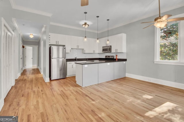 kitchen with white cabinetry, light hardwood / wood-style floors, backsplash, pendant lighting, and appliances with stainless steel finishes