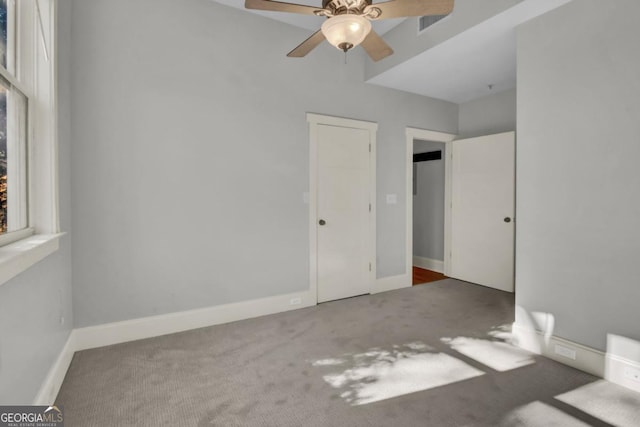 unfurnished room featuring ceiling fan and carpet flooring