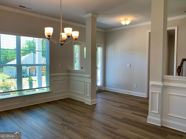 unfurnished dining area featuring an inviting chandelier, ornamental molding, and plenty of natural light