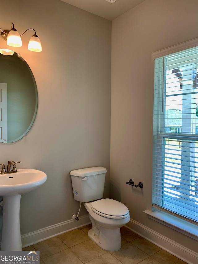 bathroom featuring sink, tile patterned floors, and toilet