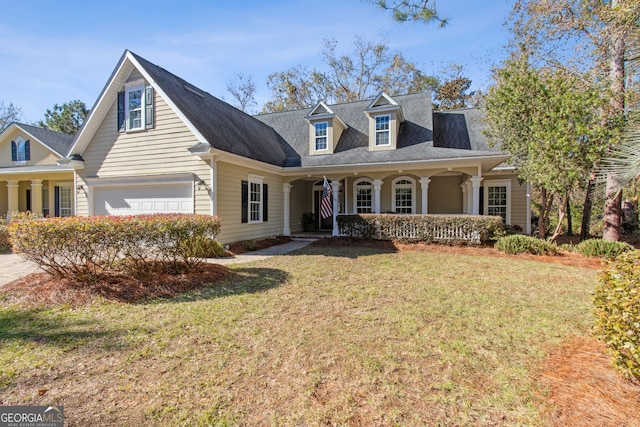 new england style home featuring a garage, a porch, and a front lawn