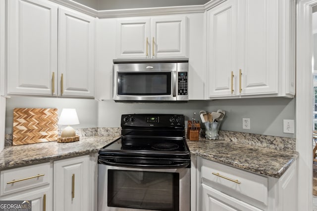 kitchen featuring light stone countertops, white cabinetry, and appliances with stainless steel finishes