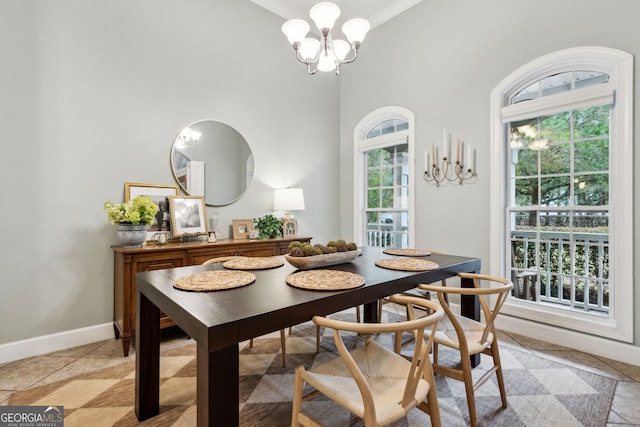 tiled dining space with a chandelier, a wealth of natural light, and ornamental molding