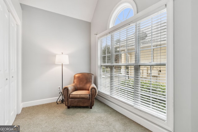 sitting room with vaulted ceiling, a wealth of natural light, and carpet flooring