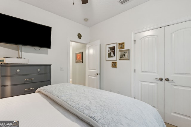 bedroom with ceiling fan and a closet