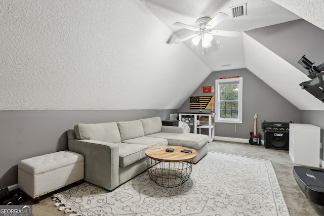 carpeted living room featuring vaulted ceiling, a textured ceiling, and ceiling fan