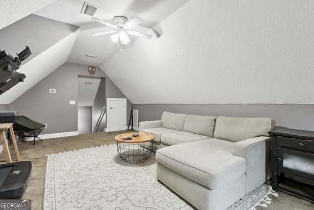 carpeted living room with a textured ceiling, ceiling fan, and vaulted ceiling